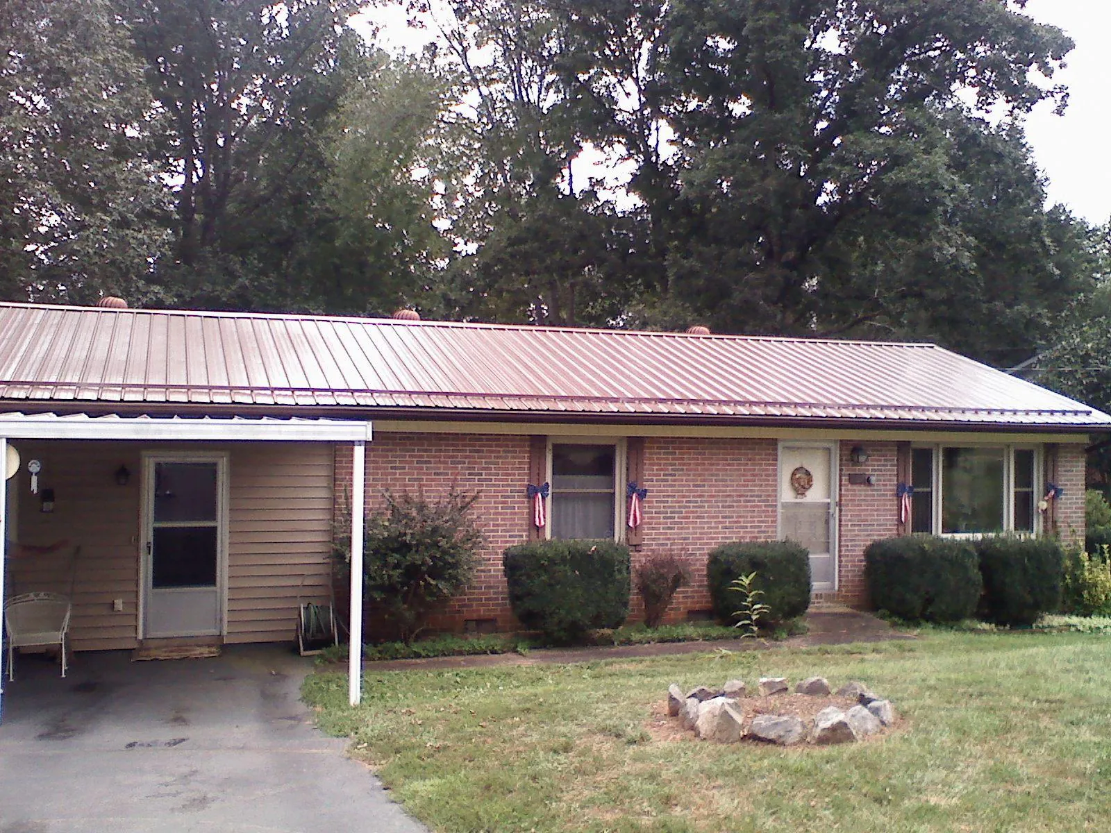 Bronze metal roof and carport on a brick ranch home — Roof Repair work by our crew in Passaic