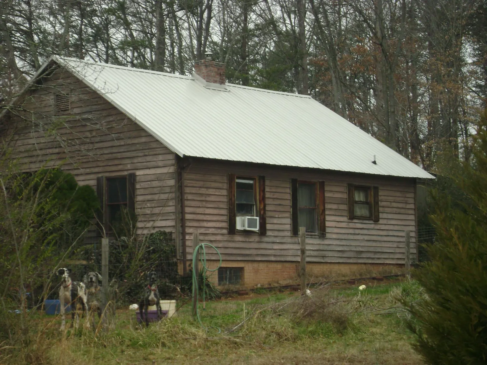 White metal roof on an old wood sided farmhouse, from a Metal Roof Installation job in Passaic